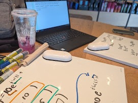 Whiteboard and laptop during an in-person tutoring session